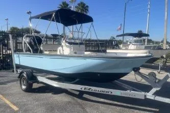 Slide: The Image of 2023 Boston Whaler 170 Montauk boat on trailer, featuring a sleek design and canopy. - 4