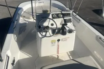 Slide: The Image of 2023 Boston Whaler 170 Montauk boat interior with steering console and seating. - 8