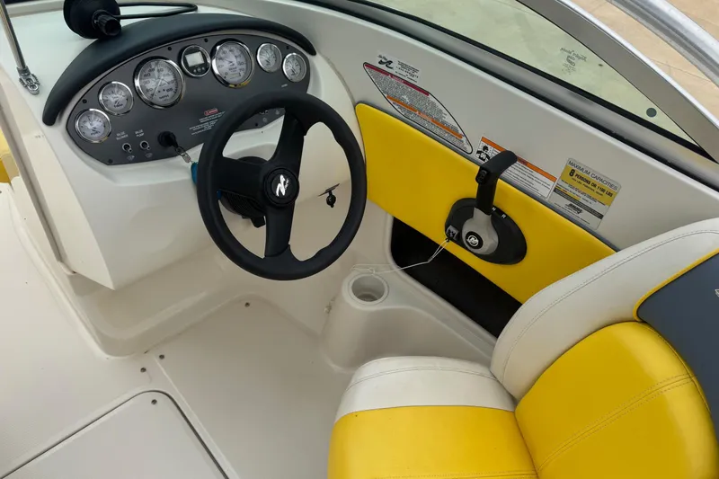 Slide: The Image of 2006 Sea Ray 195 Sport boat interior with steering wheel and yellow seating. - 5