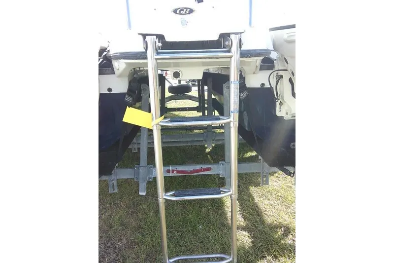 Slide: The Image of 2003 Glacier Bay 2240 Dual Console boat with stainless steel ladder on grass. - 10