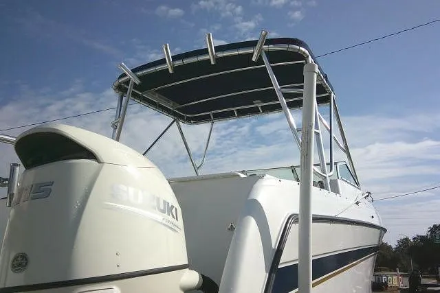 Slide: The Image of 2003 Glacier Bay 2240 Dual Console boat with Suzuki outboard motor under a clear sky. - 13