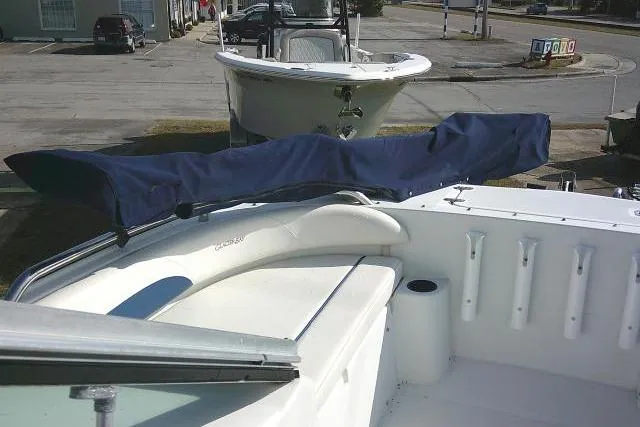 Slide: The Image of 2003 Glacier Bay 2240 Dual Console boat with covered seating, docked in a marina. - 14