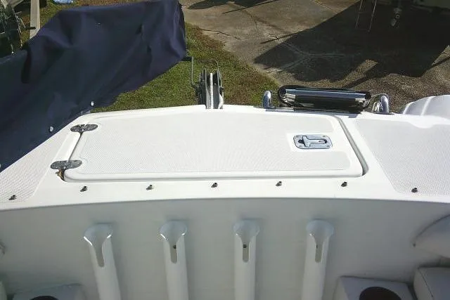 Slide: The Image of 2003 Glacier Bay 2240 Dual Console boat deck with storage hatch and rod holders. - 17