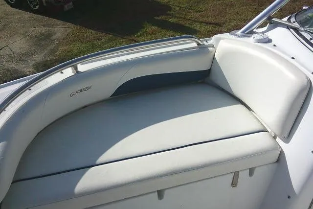 Slide: The Image of 2003 Glacier Bay 2240 Dual Console boat with white cushioned seating. - 20