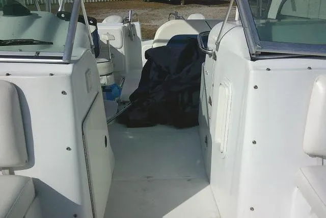 Slide: The Image of 2003 Glacier Bay 2240 Dual Console boat interior with seating and storage areas. - 23
