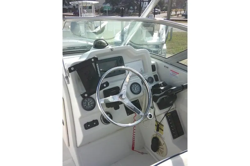 Slide: The Image of 2003 Glacier Bay 2240 Dual Console boat dashboard with steering wheel and controls. - 26
