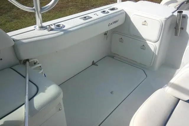 Slide: The Image of 2003 Glacier Bay 2240 Dual Console boat interior, featuring seating and storage compartments. - 29