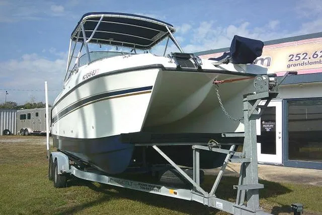 Slide: The Image of 2003 Glacier Bay 2240 Dual Console boat on trailer, parked outdoors. - 3