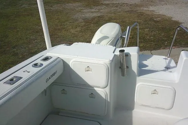 Slide: The Image of 2003 Glacier Bay 2240 Dual Console boat interior with storage compartments and seating. - 30