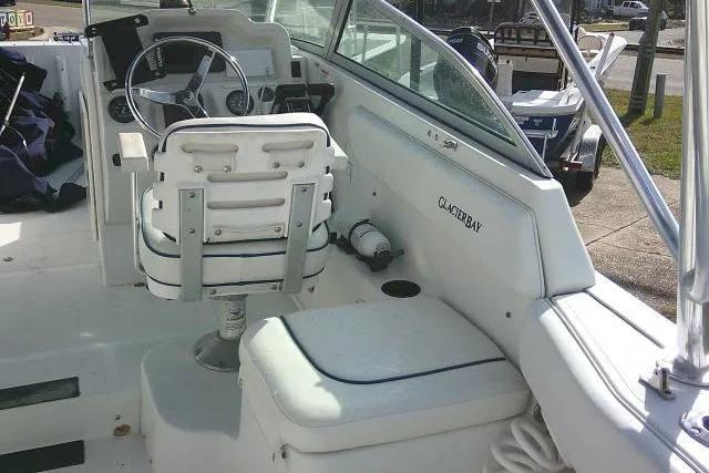 Slide: The Image of 2003 Glacier Bay 2240 Dual Console boat interior with steering wheel and seating. - 34