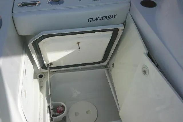 Slide: The Image of 2003 Glacier Bay 2240 Dual Console boat storage compartment open. - 35