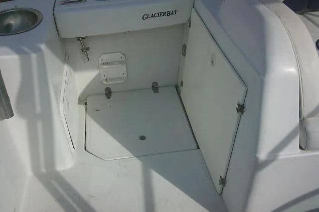 Slide: The Image of 2003 Glacier Bay 2240 Dual Console boat interior with storage compartment and sink. - 36