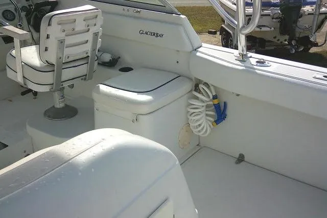 Slide: The Image of 2003 Glacier Bay 2240 Dual Console boat interior with seating and storage. - 38