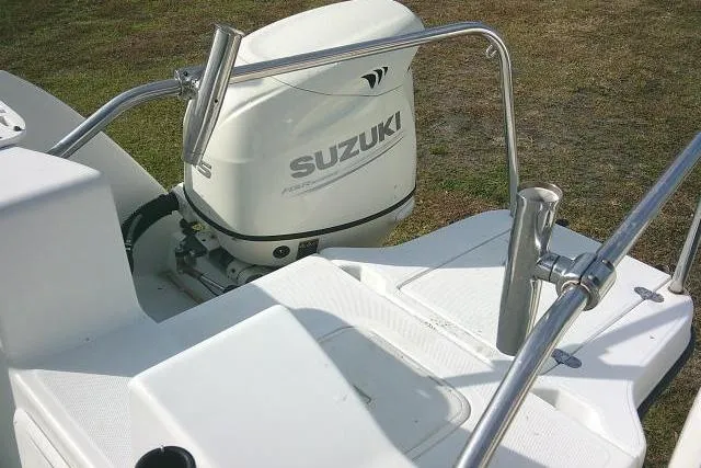 Slide: The Image of 2003 Glacier Bay 2240 Dual Console with Suzuki outboard motor, featuring stainless steel railings. - 40