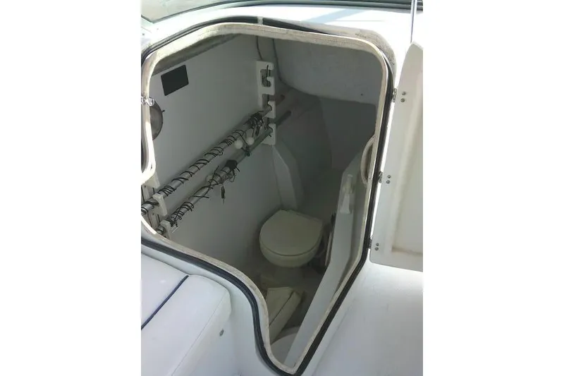 Slide: The Image of 2003 Glacier Bay 2240 Dual Console boat interior with compact marine toilet. - 43