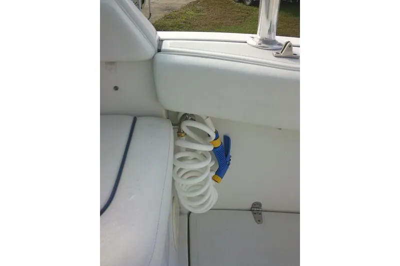 Slide: The Image of Coiled hose and nozzle on 2003 Glacier Bay 2240 Dual Console boat interior. - 48