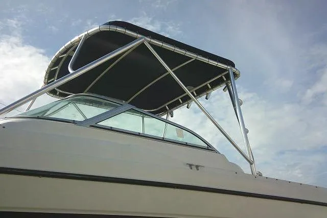 Slide: The Image of 2003 Glacier Bay 2240 Dual Console boat with canopy against a blue sky. - 7