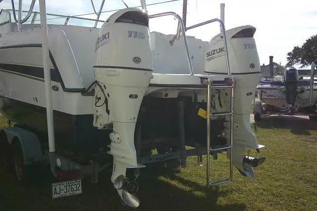 Slide: The Image of 2003 Glacier Bay 2240 Dual Console boat with twin Suzuki 115 engines on trailer. - 8