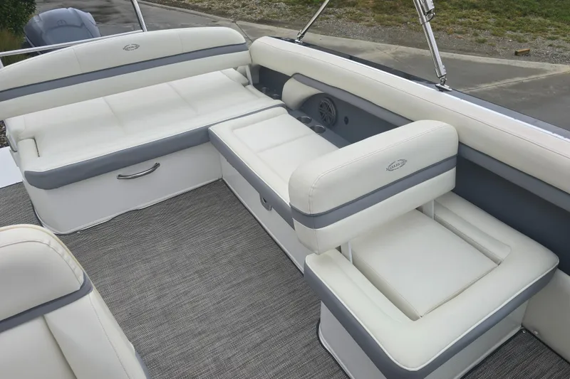 Slide: The Image of Luxurious seating on 2016 Marker One ML4 boat, featuring white and gray upholstery. - 12