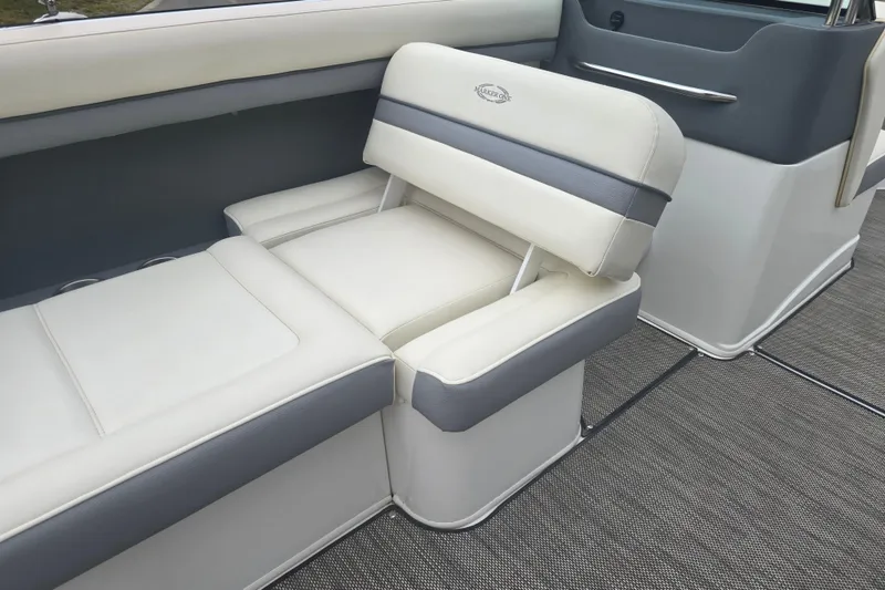 Slide: The Image of Luxurious seating on 2016 Marker One ML4 boat, featuring white and gray upholstery. - 13