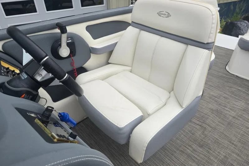 Slide: The Image of Captain's seat in a 2016 Marker One ML4 boat, featuring a sleek steering wheel. - 16