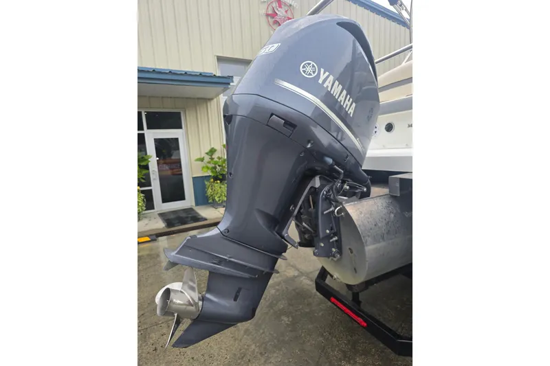 Slide: The Image of Outboard motor on a 2016 Marker One ML4 boat, displayed outside a building. - 3