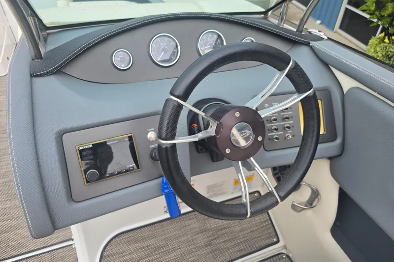 Slide: The Image of Steering wheel and dashboard of 2016 Marker One ML4 boat, featuring gauges and controls. - 11