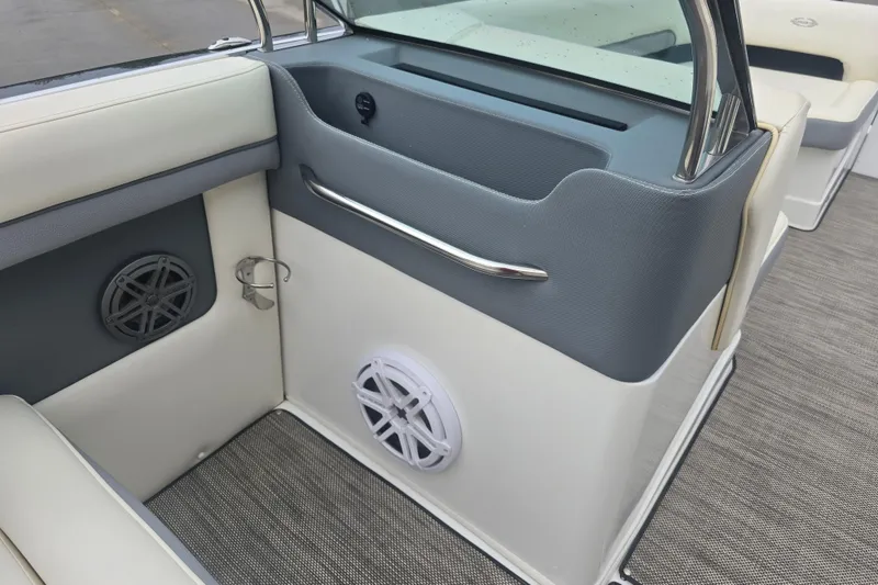 Slide: The Image of Interior of a 2016 Marker One ML4 boat featuring speakers and cushioned seating. - 12