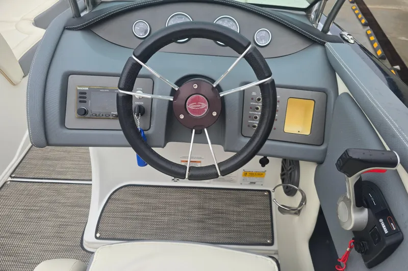 Slide: The Image of Steering console of a 2016 Marker One ML4 boat with controls and gauges. - 13