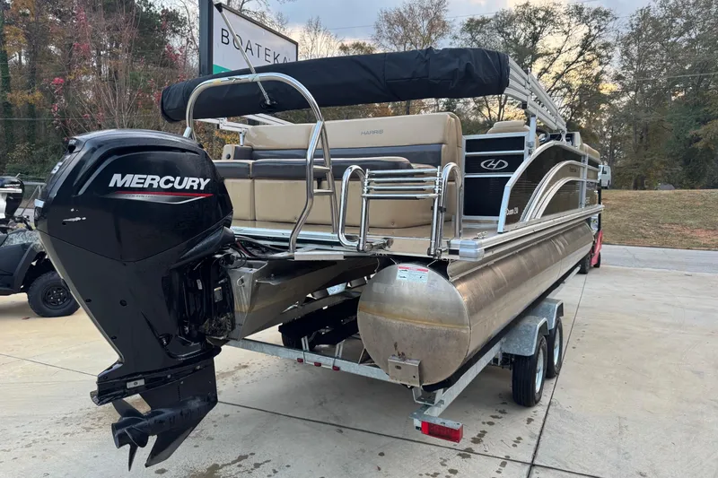 Slide: The Image of 2022 Harris Cruiser 230 pontoon boat with Mercury outboard motor on trailer. - 2