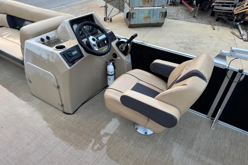Slide: The Image of 2022 Harris Cruiser 230 boat interior with steering console and captain's chair. - 5