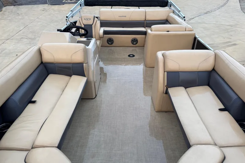 Slide: The Image of 2022 Harris Cruiser 230 boat interior with beige and gray seating. - 9