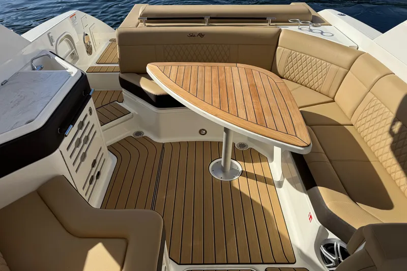 Slide: The Image of Luxurious 2026 Sea Ray SLX 310 boat interior with elegant seating and wooden table. - 10