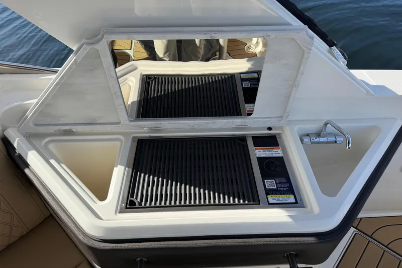Slide: The Image of Outdoor grill and sink on 2026 Sea Ray SLX 310 boat, featuring modern design. - 14
