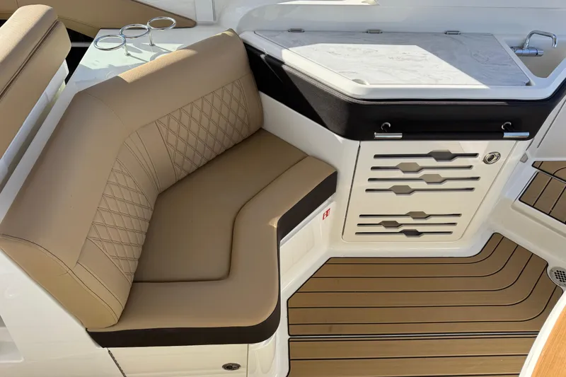 Slide: The Image of Luxurious seating and kitchenette on 2026 Sea Ray SLX 310 boat interior. - 15