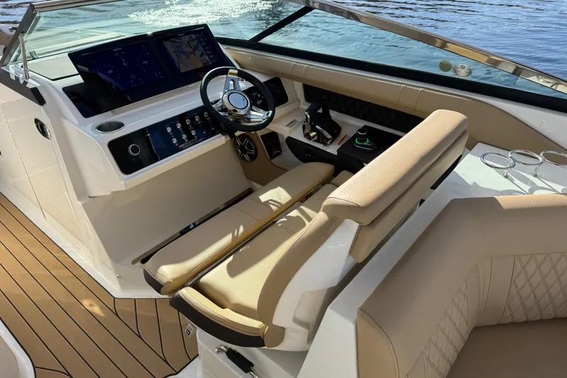 Slide: The Image of 2026 Sea Ray SLX 310 boat cockpit with modern controls and luxurious seating. - 16