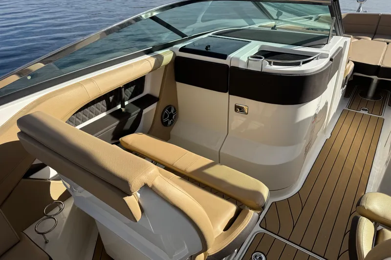 Slide: The Image of 2026 Sea Ray SLX 310 boat interior with tan seating and sleek design. - 17