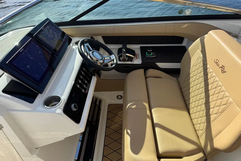 Slide: The Image of Interior of 2026 Sea Ray SLX 310 boat with modern dashboard and leather seating. - 18