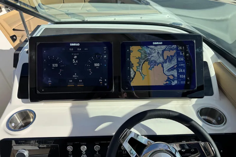 Slide: The Image of 2026 Sea Ray SLX 310 dashboard with dual Simrad displays showing navigation and engine data. - 21