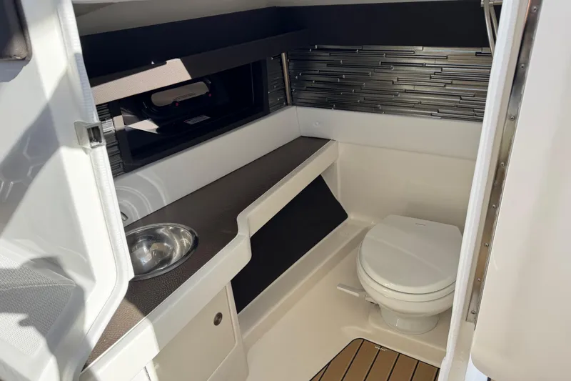 Slide: The Image of 2026 Sea Ray SLX 310 boat interior with modern bathroom amenities. - 22