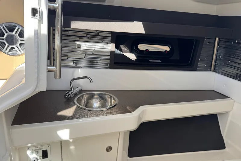 Slide: The Image of 2026 Sea Ray SLX 310 boat interior with sink and modern design elements. - 23