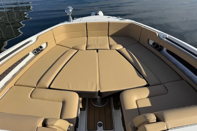Slide: The Image of 2026 Sea Ray SLX 310 boat with luxurious tan seating and spacious deck. - 30