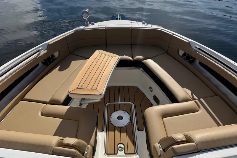 Slide: The Image of Luxurious interior of 2026 Sea Ray SLX 310 boat with tan seating and wooden table. - 31