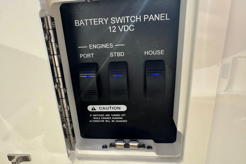 Slide: The Image of Battery switch panel on 2026 Sea Ray SLX 310 boat, featuring engine and house controls. - 34