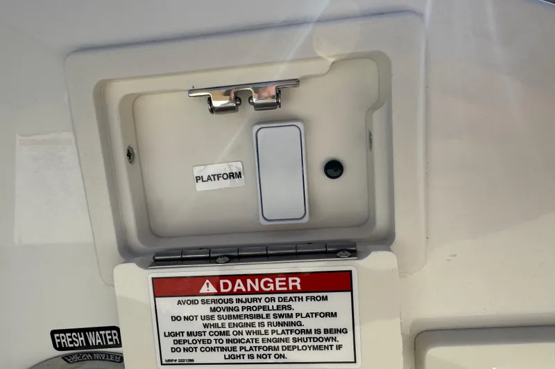 Slide: The Image of Control panel on 2026 Sea Ray SLX 310 boat with safety warning labels. - 35