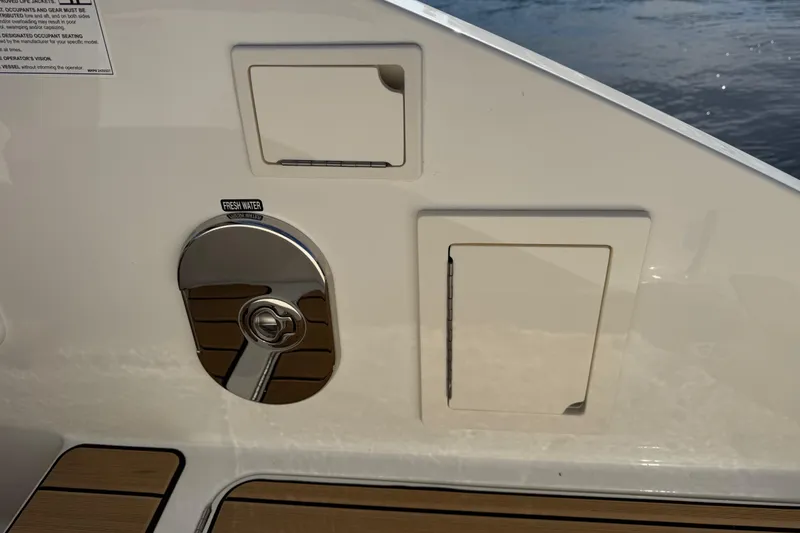 Slide: The Image of 2026 Sea Ray SLX 310 boat detail showing fresh water access and storage compartments. - 36