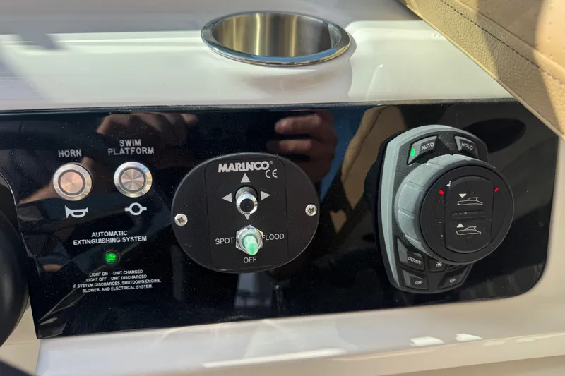 Slide: The Image of Control panel of 2026 Sea Ray SLX 310 boat with various switches and dials. - 40