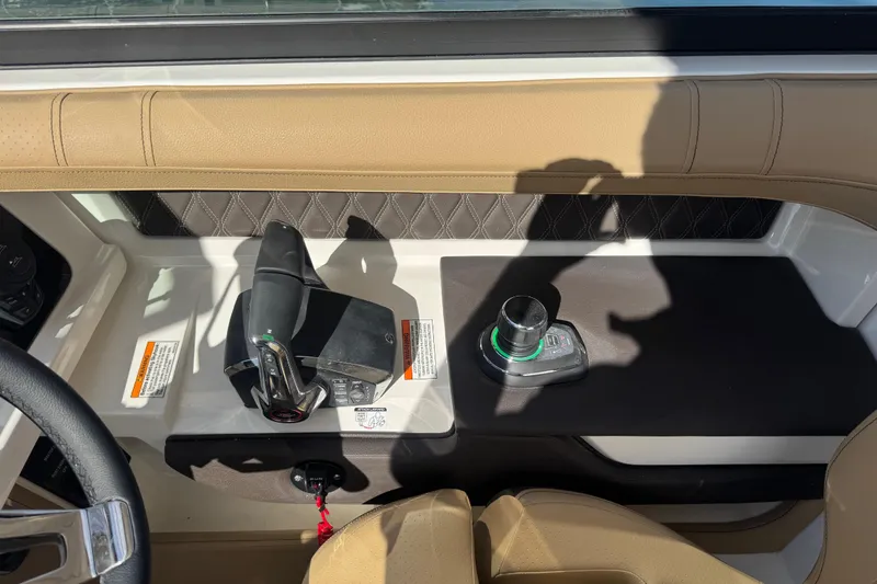 Slide: The Image of 2026 Sea Ray SLX 310 helm with modern controls and luxurious tan upholstery. - 41
