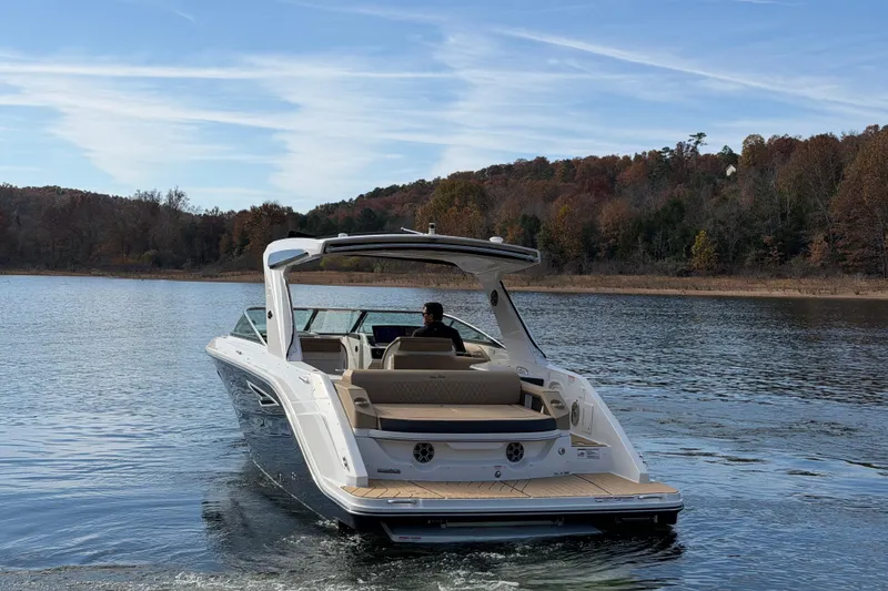 Slide: The Image of 2026 Sea Ray SLX 310 cruising on a serene lake with autumn foliage. - 5