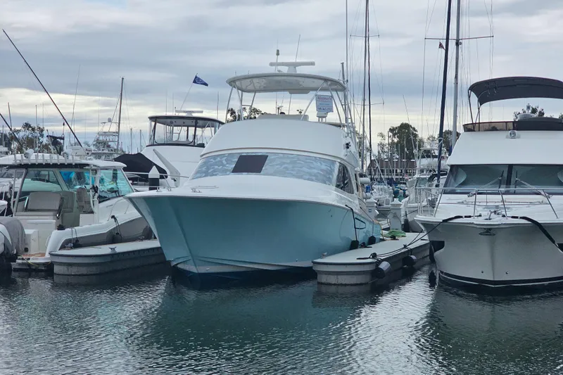 Slide: The Image of 2013 Viking 42 Convertible yacht docked at marina, surrounded by other boats. - 11